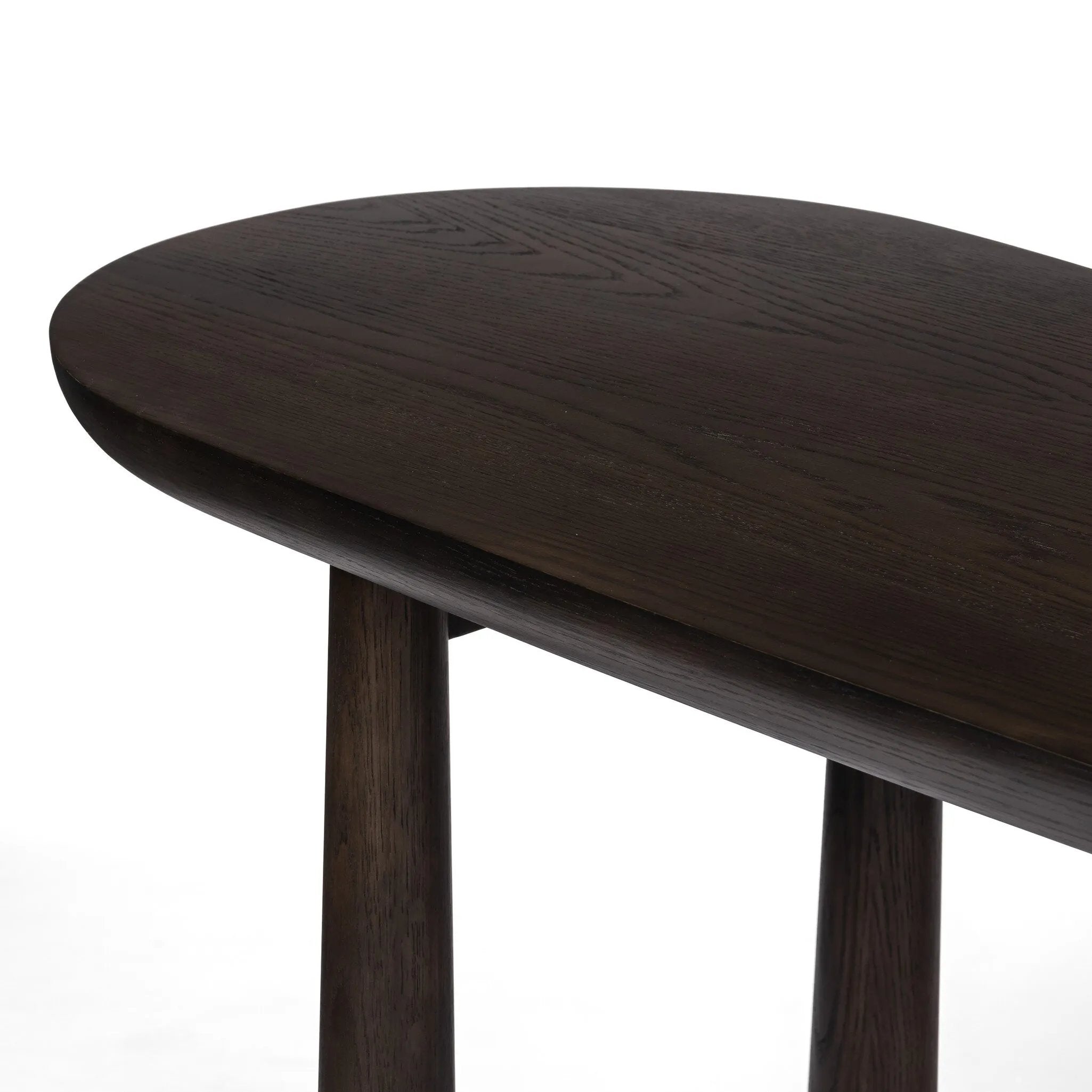 A smoothly shaped desk of brown oak veneer stands on tapered, cylindrical legs, meeting clean lines with an organic aesthetic.Collection: Westgat Amethyst Home provides interior design, new home construction design consulting, vintage area rugs, and lighting in the Nashville metro area.