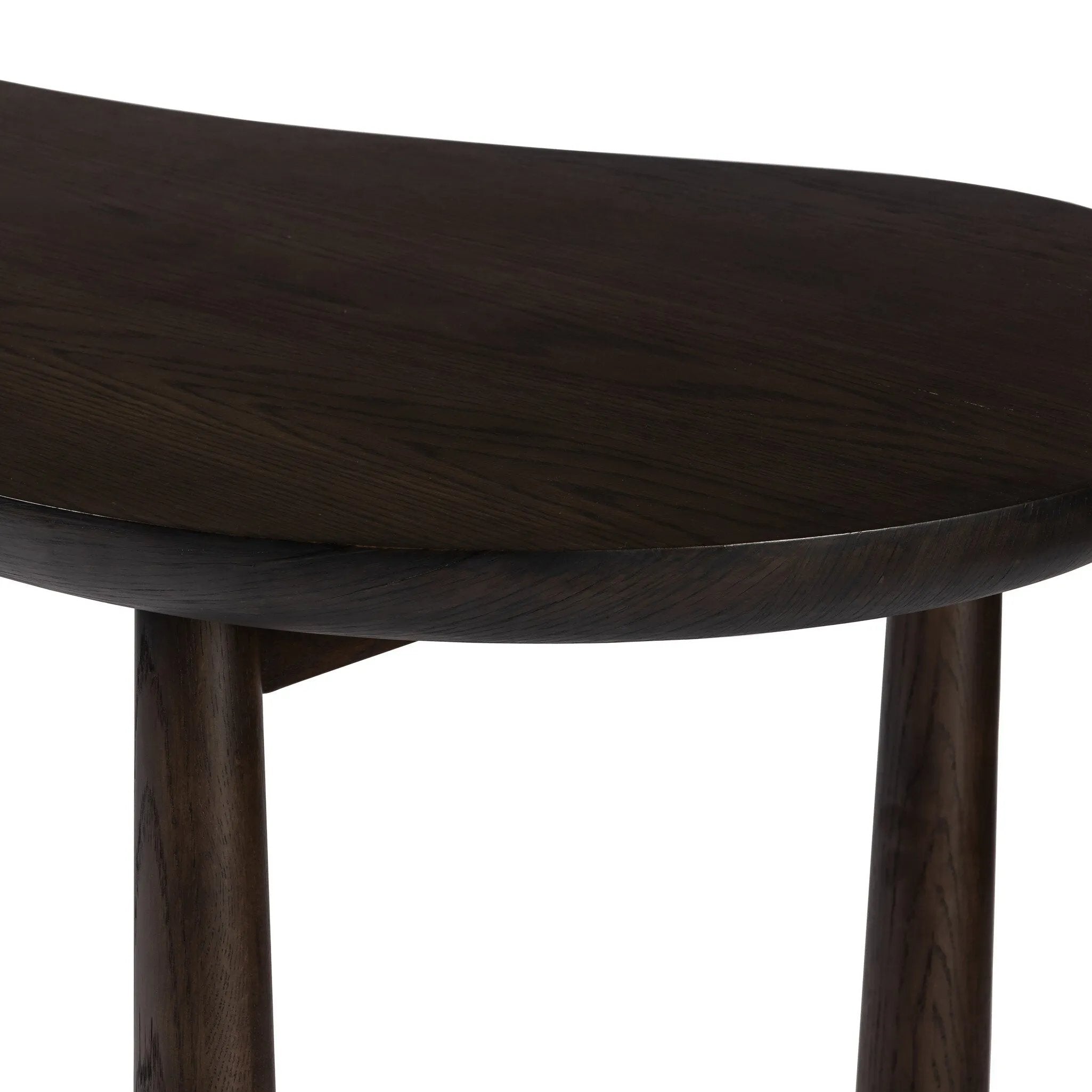 A smoothly shaped desk of brown oak veneer stands on tapered, cylindrical legs, meeting clean lines with an organic aesthetic.Collection: Westgat Amethyst Home provides interior design, new home construction design consulting, vintage area rugs, and lighting in the Newport Beach metro area.