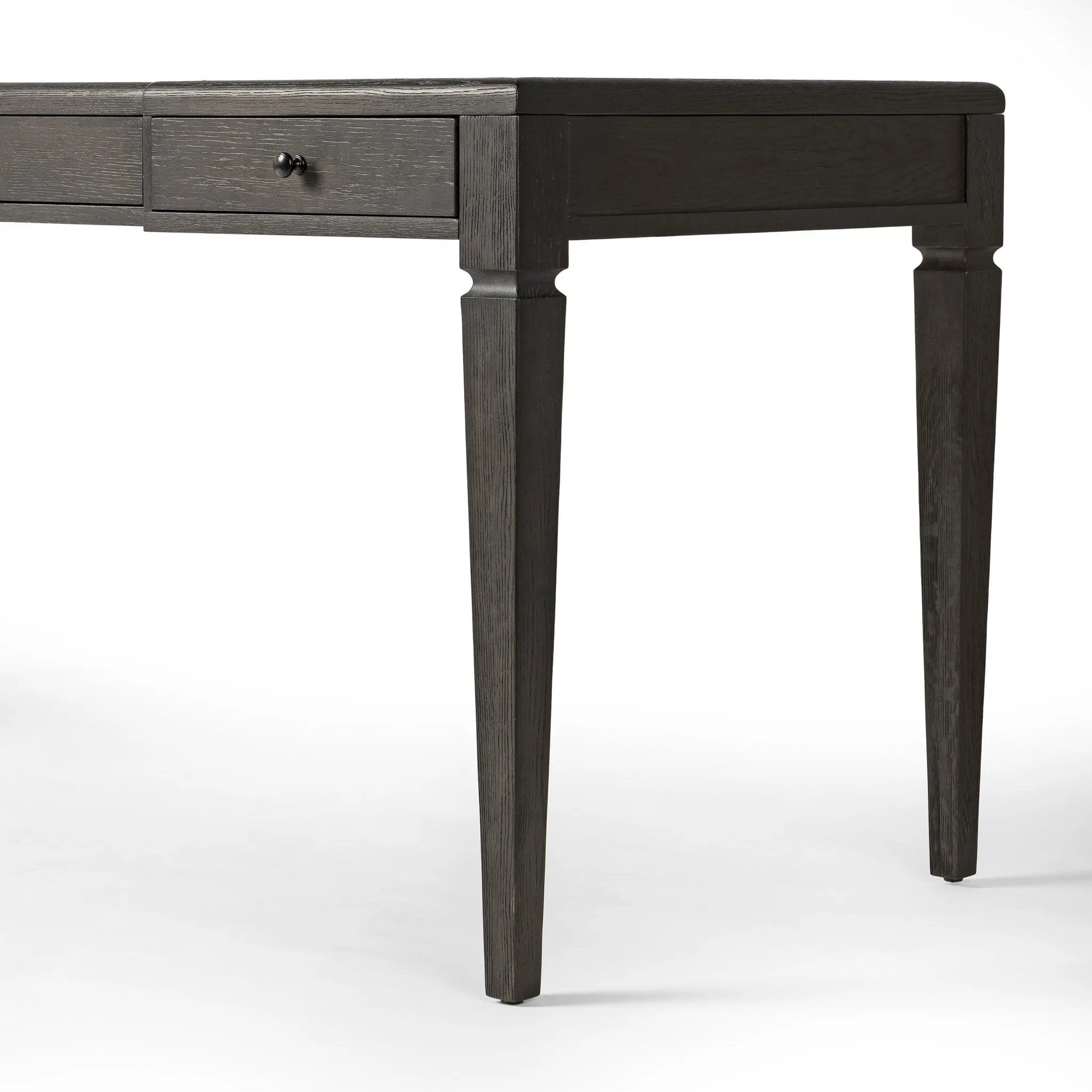 This refreshed directoire-style desk pairs a 100% top-grain leather inset top with a unique reverse breakfront and recessed center drawer. Finished in distressed black oak, it offers the workspace a classic yet updated feel.Collection: Allsto Amethyst Home provides interior design, new home construction design consulting, vintage area rugs, and lighting in the Austin metro area.