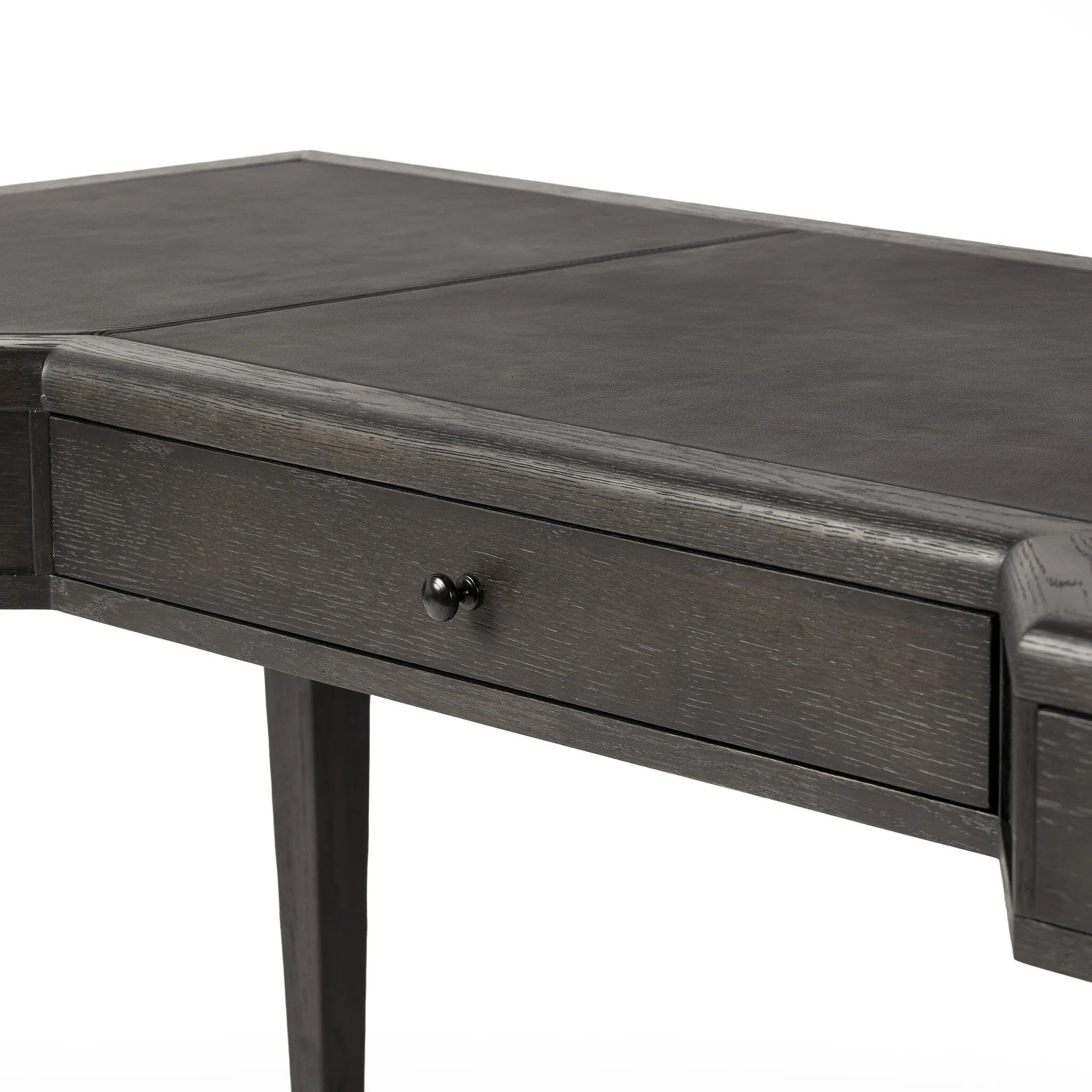 This refreshed directoire-style desk pairs a 100% top-grain leather inset top with a unique reverse breakfront and recessed center drawer. Finished in distressed black oak, it offers the workspace a classic yet updated feel.Collection: Allsto Amethyst Home provides interior design, new home construction design consulting, vintage area rugs, and lighting in the Charlotte metro area.