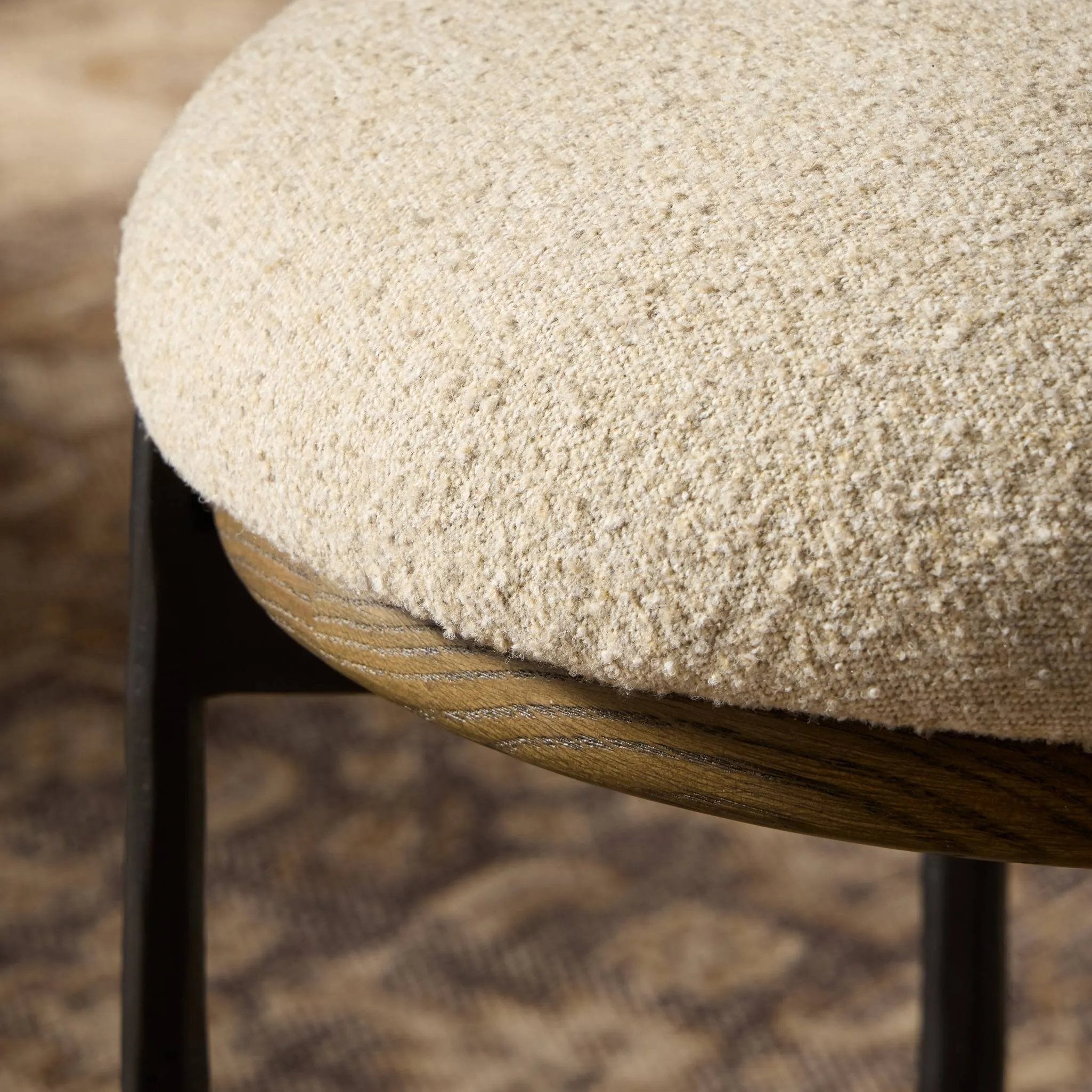 Contrasting materials come together to create an elevated counter stool. Designed with tapered cast iron legs and a solid oak