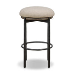 Contrasting materials come together to create an elevated counter stool. Designed with tapered cast iron legs and a solid oak seat base topped with an upholstered padded seat. Swivels 360 degrees. Seat is covered in 100% olefin, known for its UV-resistant, water-repellent and quick-drying abilities Amethyst Home provides interior design, new home construction design consulting, vintage area rugs, and lighting in the Dallas metro area.