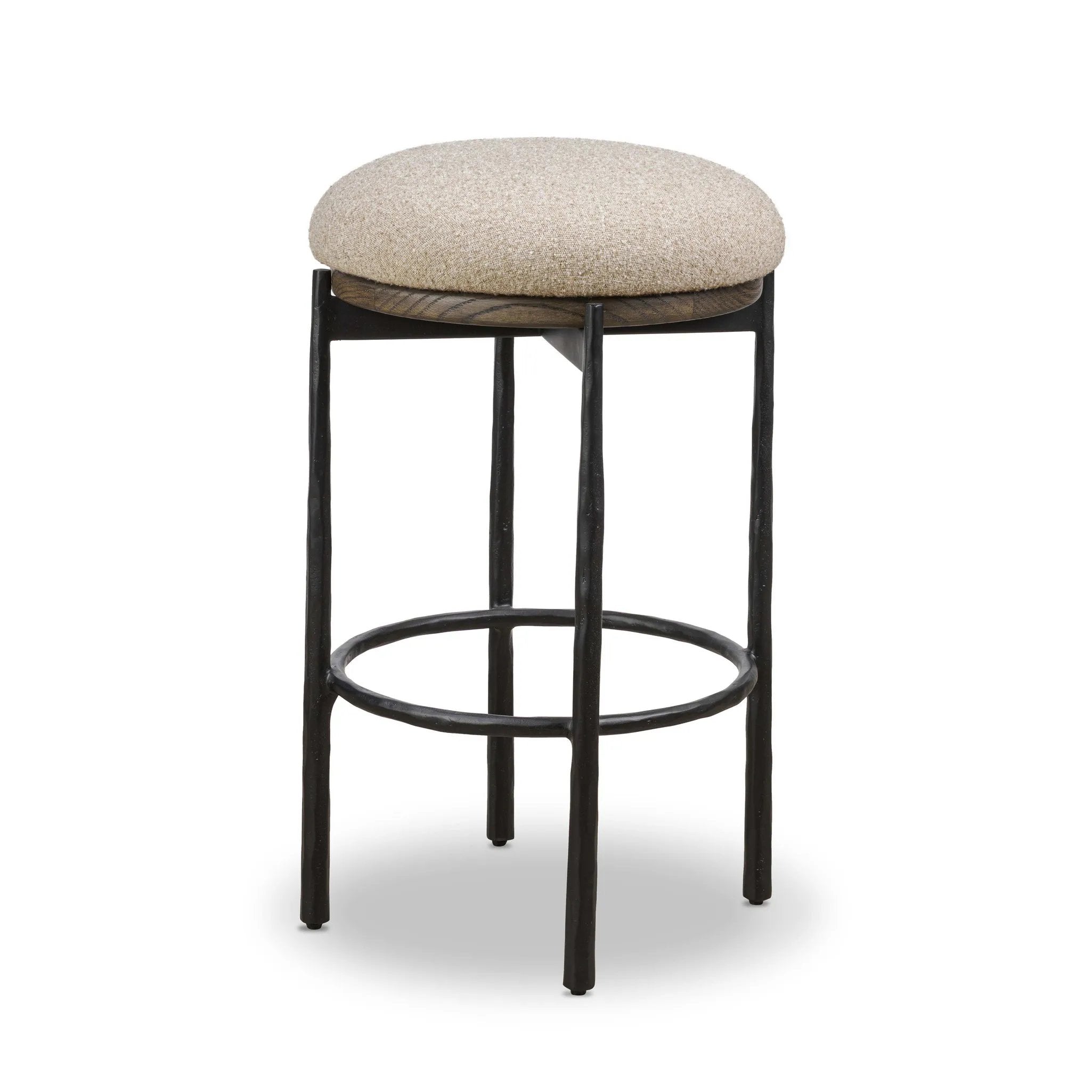 Contrasting materials come together to create an elevated counter stool. Designed with tapered cast iron legs and a solid oak