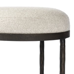 Featuring Corinne Crete Pebble Accent Stool by Four Hands at Amethyst Home. Work midcentury vibes into any space with a pared-back accent stool that doubles as a cocktail ottoman. Wrough iron legs finished in a hammered bronze pair with a simple rounded seat upholstered in a texture-rich fabric, with S-spring suspension for comfort and structure.Overall Dime. Amethyst Home provides interior design, new home construction design consulting, vintage area rugs, and lighting in the Monterey metro area.