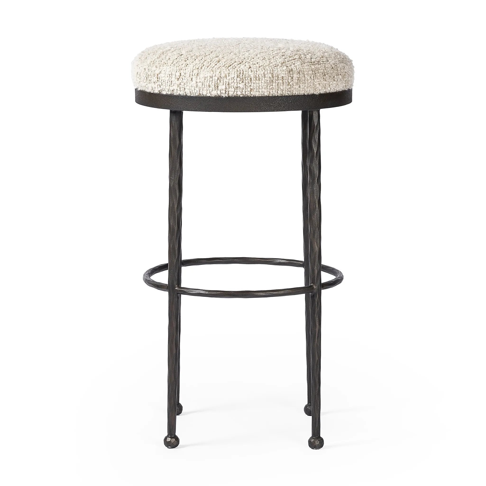 Featuring Corinne Ivan Stone Bar + Counter Stool by Four Hands at Amethyst Home. Hammered bronze legs with ball-shaped foot details elevate this simply shaped counter stool. A round, cushioned seat in a heavy boucle-like fabric finishes this counter-height stool's clean, inviting look.BarOverall Dimensions: 17.00"w x 17.00"d x 31.25"hWeight: 32.19 lbsCounte. Amethyst Home provides interior design, new home construction design consulting, vintage area rugs, and lighting in the Charlotte metro area.