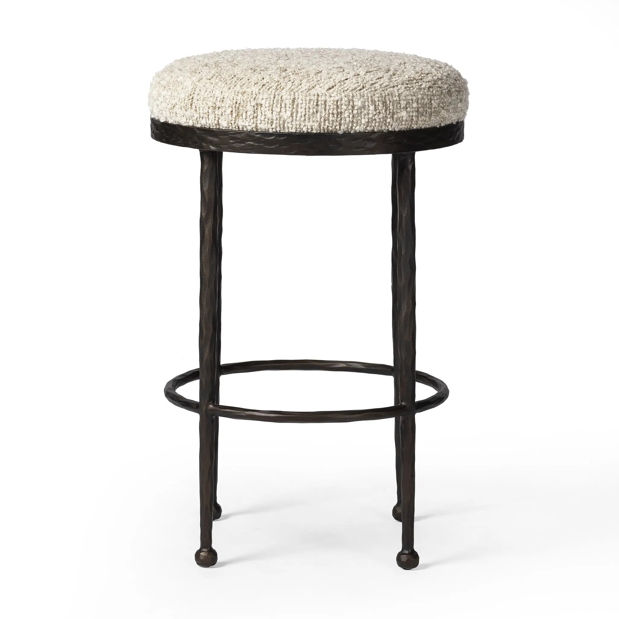 Featuring Corinne Ivan Stone Bar + Counter Stool by Four Hands at Amethyst Home. Hammered bronze legs with ball-shaped foot details elevate this simply shaped counter stool. A round, cushioned seat in a heavy boucle-like fabric finishes this counter-height stool's clean, inviting look.BarOverall Dimensions: 17.00"w x 17.00"d x 31.25"hWeight: 32.19 lbsCounterO. Amethyst Home provides interior design, new home construction design consulting, vintage area rugs, and lighting in the Houston metro area.