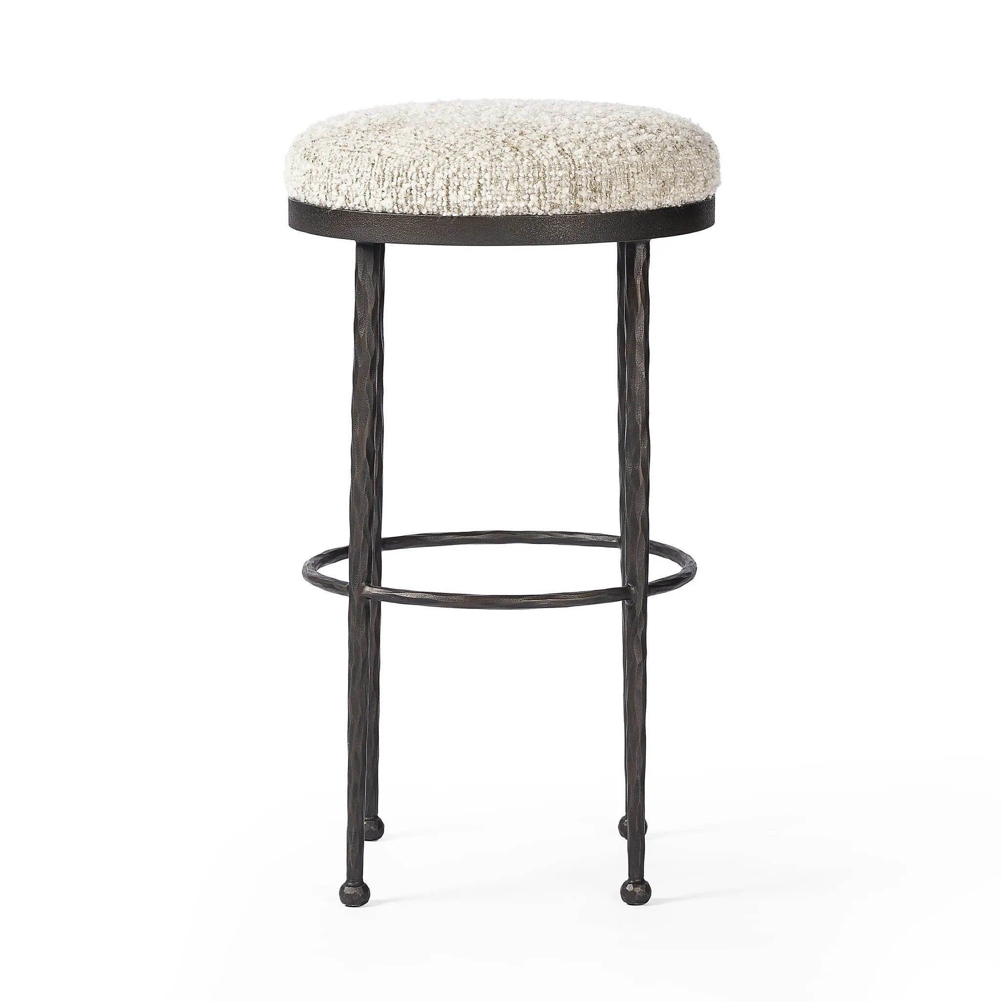 Featuring Corinne Ivan Stone Bar + Counter Stool by Four Hands at Amethyst Home. Hammered bronze legs with ball-shaped foot details elevate this simply shaped counter stool. A round, cushioned seat in a heavy boucle-like fabric finishes this counter-height stool's clean, inviting look.BarOverall Dimensions: 17.00"w x 17.00"d x 31.25"hWeight: 32.19 lbsCoun. Amethyst Home provides interior design, new home construction design consulting, vintage area rugs, and lighting in the Los Angeles metro area.
