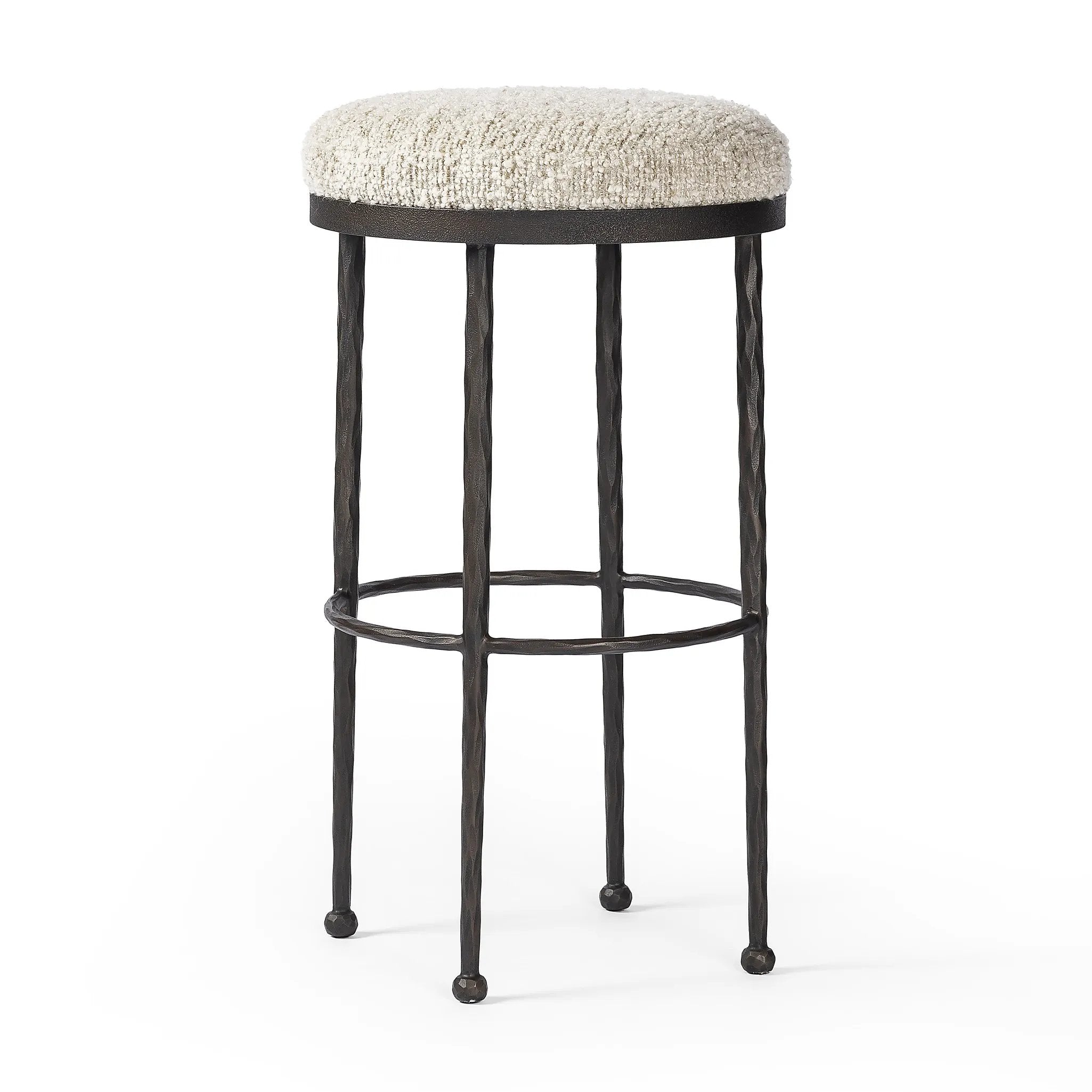 Featuring Corinne Ivan Stone Bar + Counter Stool by Four Hands at Amethyst Home. Hammered bronze legs with ball-shaped foot details elevate this simply shaped counter stool. A round, cushioned seat in a heavy boucle-like fabric finishes this counter-height stool's clean, inviting look.BarOverall Dimensions: 17.00"w x 17.00"d x 31.25"hWeight: 32.19 lbsCounterOve. Amethyst Home provides interior design, new home construction design consulting, vintage area rugs, and lighting in the Omaha metro area.