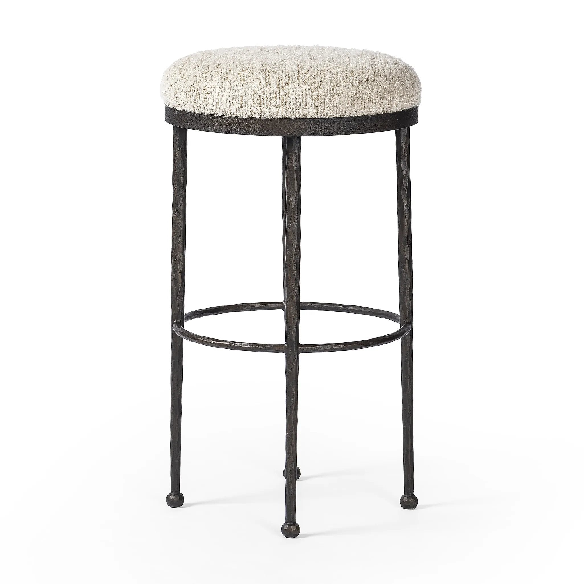 Featuring Corinne Ivan Stone Bar + Counter Stool by Four Hands at Amethyst Home. Hammered bronze legs with ball-shaped foot details elevate this simply shaped counter stool. A round, cushioned seat in a heavy boucle-like fabric finishes this counter-height stool's clean, inviting look.BarOverall Dimensions: 17.00"w x 17.00"d x 31.25"hWeight: 32.19 lbsCounte. Amethyst Home provides interior design, new home construction design consulting, vintage area rugs, and lighting in the Park City metro area.