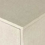 Talk about novelty. Made from painted linen in a light ivory, arched legs soften otherwise clean, modern shaping. Finished in