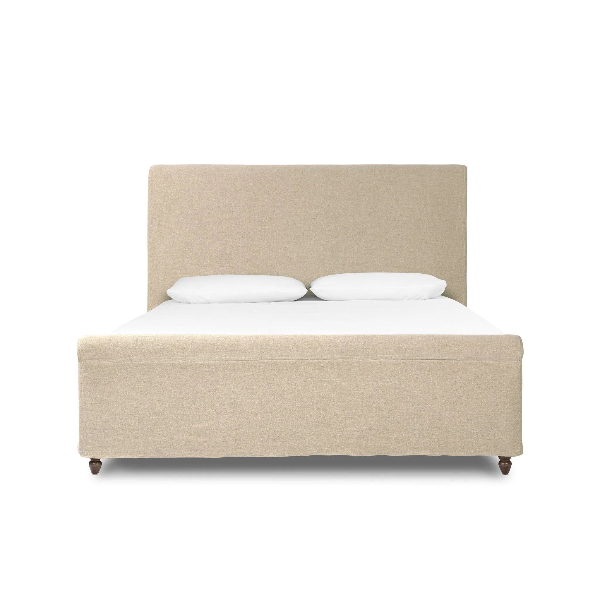 This heritage-style bed reimagines the classic sleigh silhouette. Cream-colored, linen-like fabric slipcover is both removable and washable for practicality. Turned feet in brown parawood peek from under the slip, grounding the bed's stately charm. A design collaboration by Amber Lewis and Four Hands. Amethyst Home provides interior design, new home construction design consulting, vintage area rugs, and lighting in the Charlotte metro area.