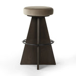 Featuring Damon Sapphire Khaki  Swivel Bar + Counter Stool by Four Hands at Amethyst Home. Large angular panels merge to form a geometrically inspired base in this modern counter stool. The circle metal ring around the base serves as a footrest, while the round upholstered cushion provides comfortable seating. The 360-degree swivel function adds versatility. Amethyst Home provides interior design, new home construction design consulting, vintage area rugs, and lighting in the Charlotte metro area.