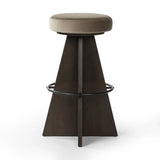 Featuring Damon Sapphire Khaki  Swivel Bar + Counter Stool by Four Hands at Amethyst Home. Large angular panels merge to form a geometrically inspired base in this modern counter stool. The circle metal ring around the base serves as a footrest, while the round upholstered cushion provides comfortable seating. The 360-degree swivel function adds versatility. Amethyst Home provides interior design, new home construction design consulting, vintage area rugs, and lighting in the Charlotte metro area.