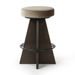 Featuring Damon Sapphire Khaki  Swivel Bar + Counter Stool by Four Hands at Amethyst Home. Large angular panels merge to form a geometrically inspired base in this modern counter stool. The circle metal ring around the base serves as a footrest, while the round upholstered cushion provides comfortable seating. The 360-degree swivel function adds versati. Amethyst Home provides interior design, new home construction design consulting, vintage area rugs, and lighting in the Newport Beach metro area.