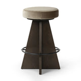 Featuring Damon Sapphire Khaki  Swivel Bar + Counter Stool by Four Hands at Amethyst Home. Large angular panels merge to form a geometrically inspired base in this modern counter stool. The circle metal ring around the base serves as a footrest, while the round upholstered cushion provides comfortable seating. The 360-degree swivel function adds versati. Amethyst Home provides interior design, new home construction design consulting, vintage area rugs, and lighting in the Newport Beach metro area.