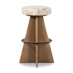 Large angular panels merge to form a geometrically inspired base in this modern counter stool. The circle metal ring around the base serves as a footrest, while the round upholstered cushion provides comfortable seating. The 360-degree swivel function adds versatility, and the combination of wood, metal, and fabric evoke a mixed material moment Amethyst Home provides interior design, new home construction design consulting, vintage area rugs, and lighting in the Monterey metro area.