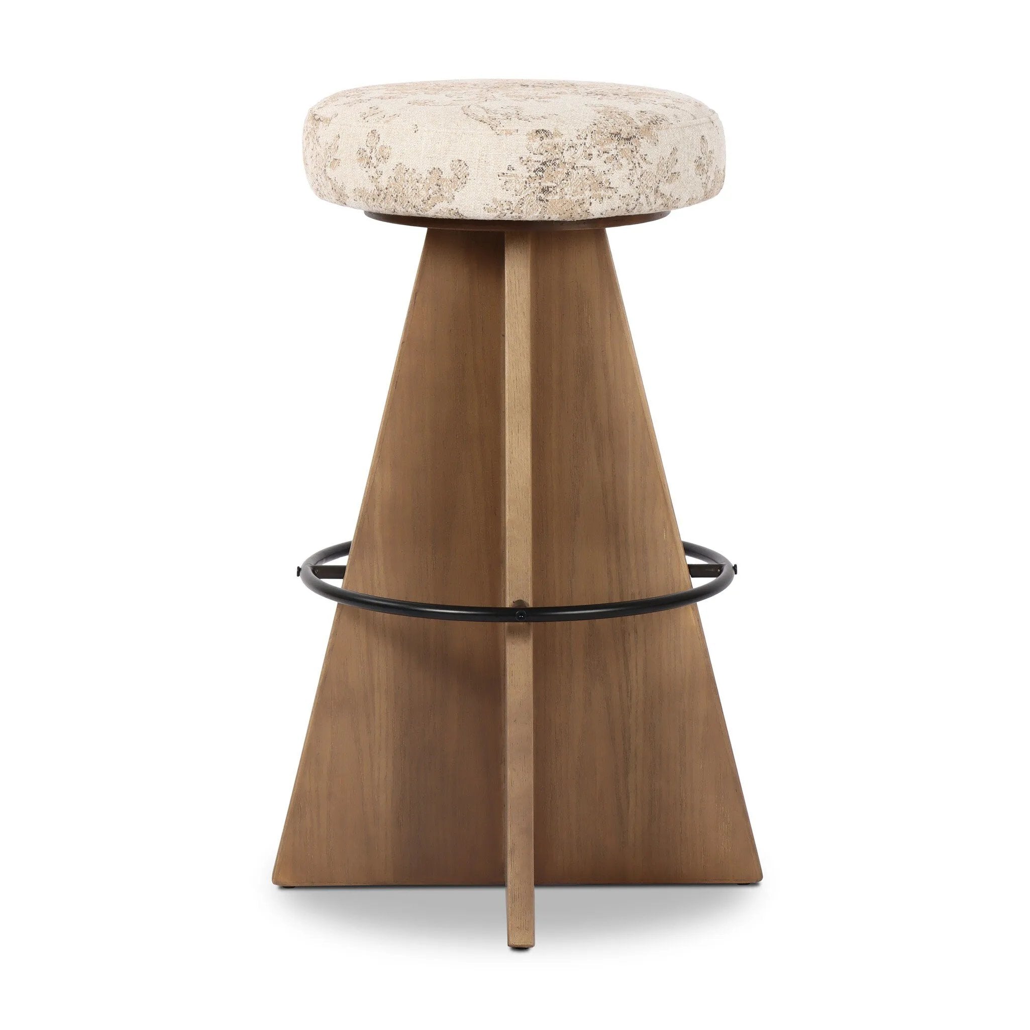 Large angular panels merge to form a geometrically inspired base in this modern counter stool. The circle metal ring around the base serves as a footrest, while the round upholstered cushion provides comfortable seating. The 360-degree swivel function adds versatility, and the combination of wood, metal, and fabric evoke a mixed material moment Amethyst Home provides interior design, new home construction design consulting, vintage area rugs, and lighting in the Monterey metro area.