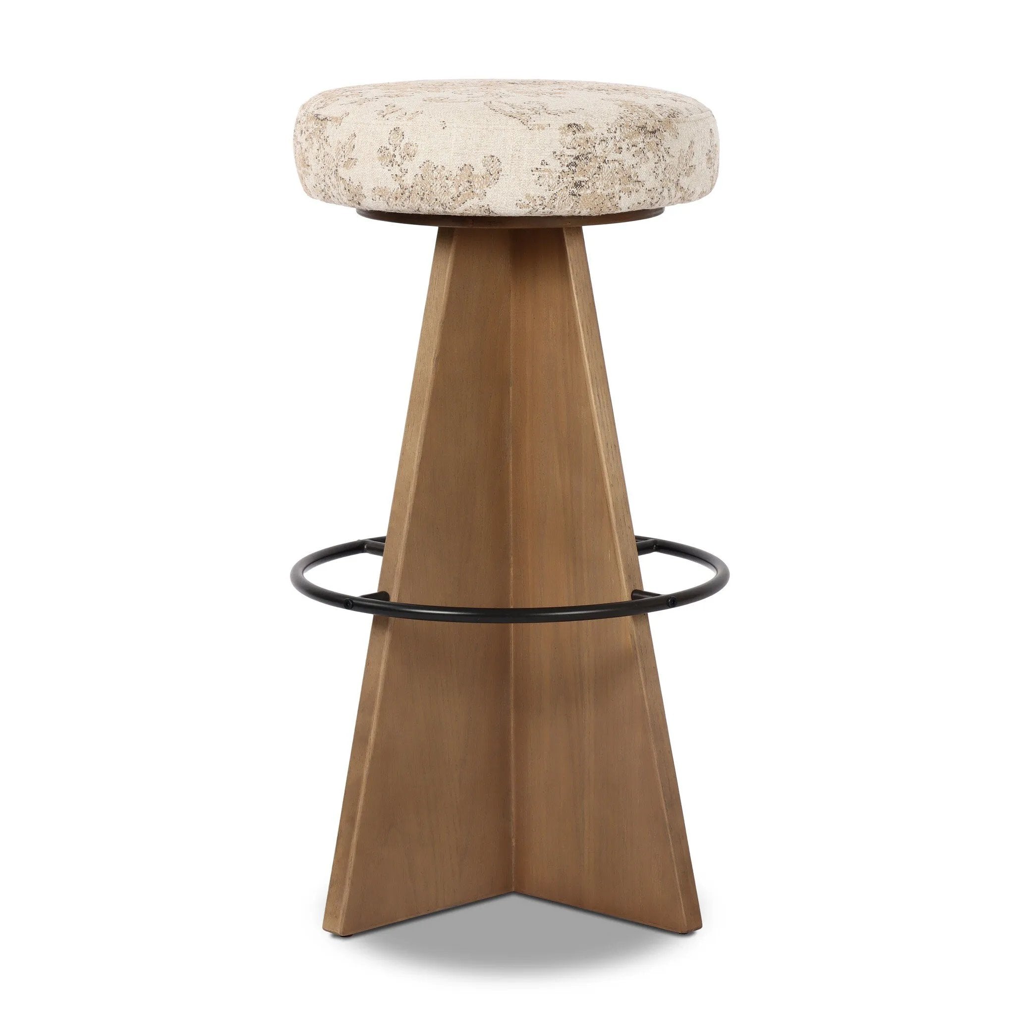 Large angular panels merge to form a geometrically inspired base in this modern counter stool. The circle metal ring around the base serves as a footrest, while the round upholstered cushion provides comfortable seating. The 360-degree swivel function adds versatility, and the combination of wood, metal, and fabric evoke a mixed material moment Amethyst Home provides interior design, new home construction design consulting, vintage area rugs, and lighting in the Omaha metro area.
