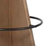 Large angular panels merge to form a geometrically inspired base in this modern counter stool. The circle metal ring around the base serves as a footrest, while the round upholstered cushion provides comfortable seating. The 360-degree swivel function adds versatility, and the combination of wood, metal, and fabric evoke a mixed material moment Amethyst Home provides interior design, new home construction design consulting, vintage area rugs, and lighting in the Tampa metro area.