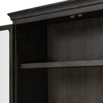 Featuring Dawes Smoked Black Oak Cabinet by Four Hands at Amethyst Home. Work the timeless charm of a vintage find into your collection. Smoked black oak cabinetry features softened mullions and rounded glass panels, with aged bronze barrel hinges and finial detailing. Generous storage and display options empower you to create a space that tells your s. Amethyst Home provides interior design, new home construction design consulting, vintage area rugs, and lighting in the Salt Lake City metro area.