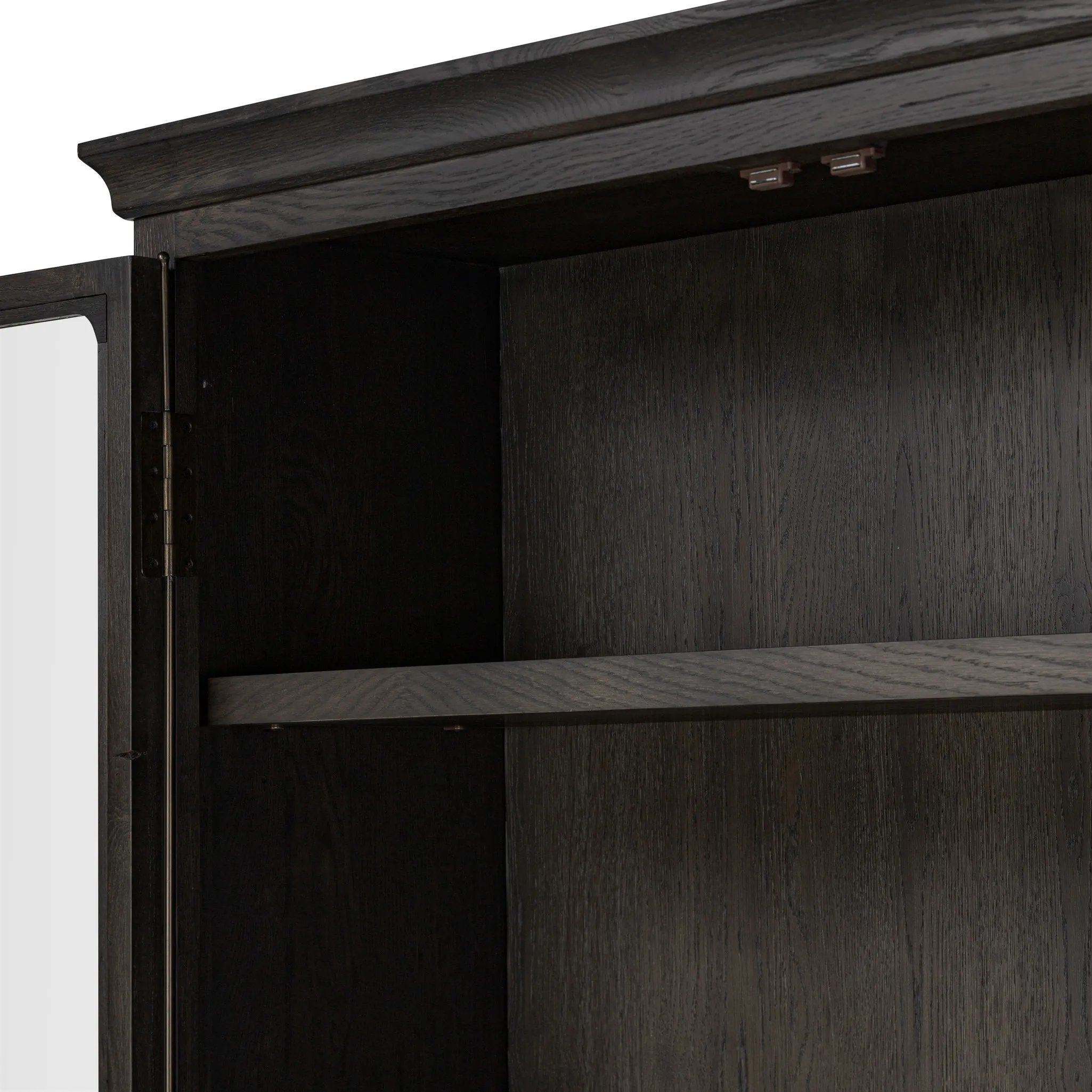 Featuring Dawes Smoked Black Oak Cabinet by Four Hands at Amethyst Home. Work the timeless charm of a vintage find into your collection. Smoked black oak cabinetry features softened mullions and rounded glass panels, with aged bronze barrel hinges and finial detailing. Generous storage and display options empower you to create a space that tells your s. Amethyst Home provides interior design, new home construction design consulting, vintage area rugs, and lighting in the Salt Lake City metro area.