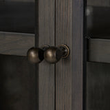 Featuring Dawes Smoked Black Oak Cabinet by Four Hands at Amethyst Home. Work the timeless charm of a vintage find into your collection. Smoked black oak cabinetry features softened mullions and rounded glass panels, with aged bronze barrel hinges and finial detailing. Generous storage and display options empower you to create a space that tells your story.. Amethyst Home provides interior design, new home construction design consulting, vintage area rugs, and lighting in the San Diego metro area.