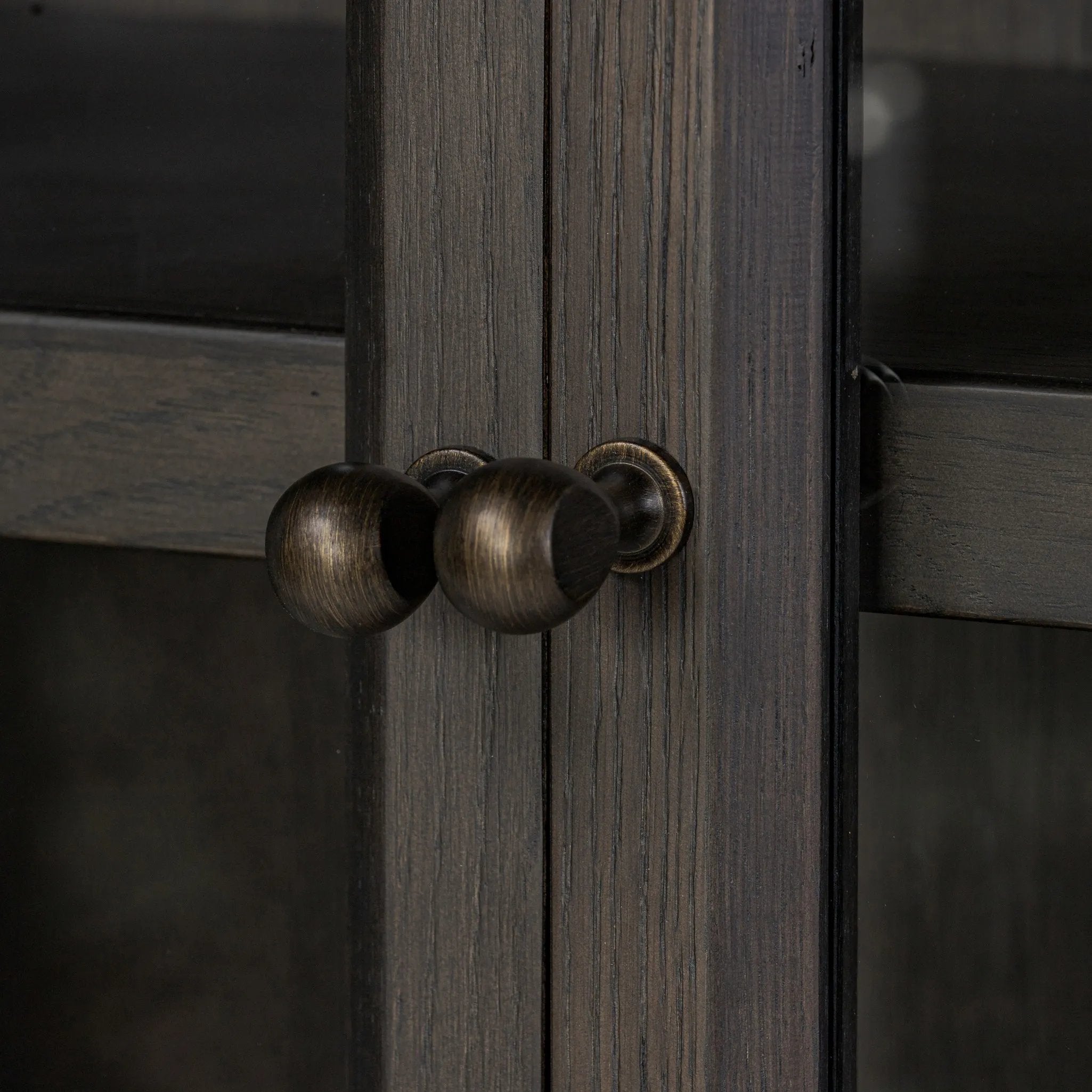 Featuring Dawes Smoked Black Oak Cabinet by Four Hands at Amethyst Home. Work the timeless charm of a vintage find into your collection. Smoked black oak cabinetry features softened mullions and rounded glass panels, with aged bronze barrel hinges and finial detailing. Generous storage and display options empower you to create a space that tells your story.. Amethyst Home provides interior design, new home construction design consulting, vintage area rugs, and lighting in the San Diego metro area.