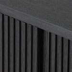 Crafted from desert oak solids and veneers with a plinth-style base, rounded sides and linear reeding, this sideboard exudes midcentury vibes. Fully finished interior and shelves for quality detailing inside and out.As enthusiasts of luxe style at Amethyst, we love the warm modern inspired Delphi Media Console - Cerused Black Oak. Amethyst Home provides interior design, new home construction design consulting, vintage area rugs, and lighting in the Dallas metro area.