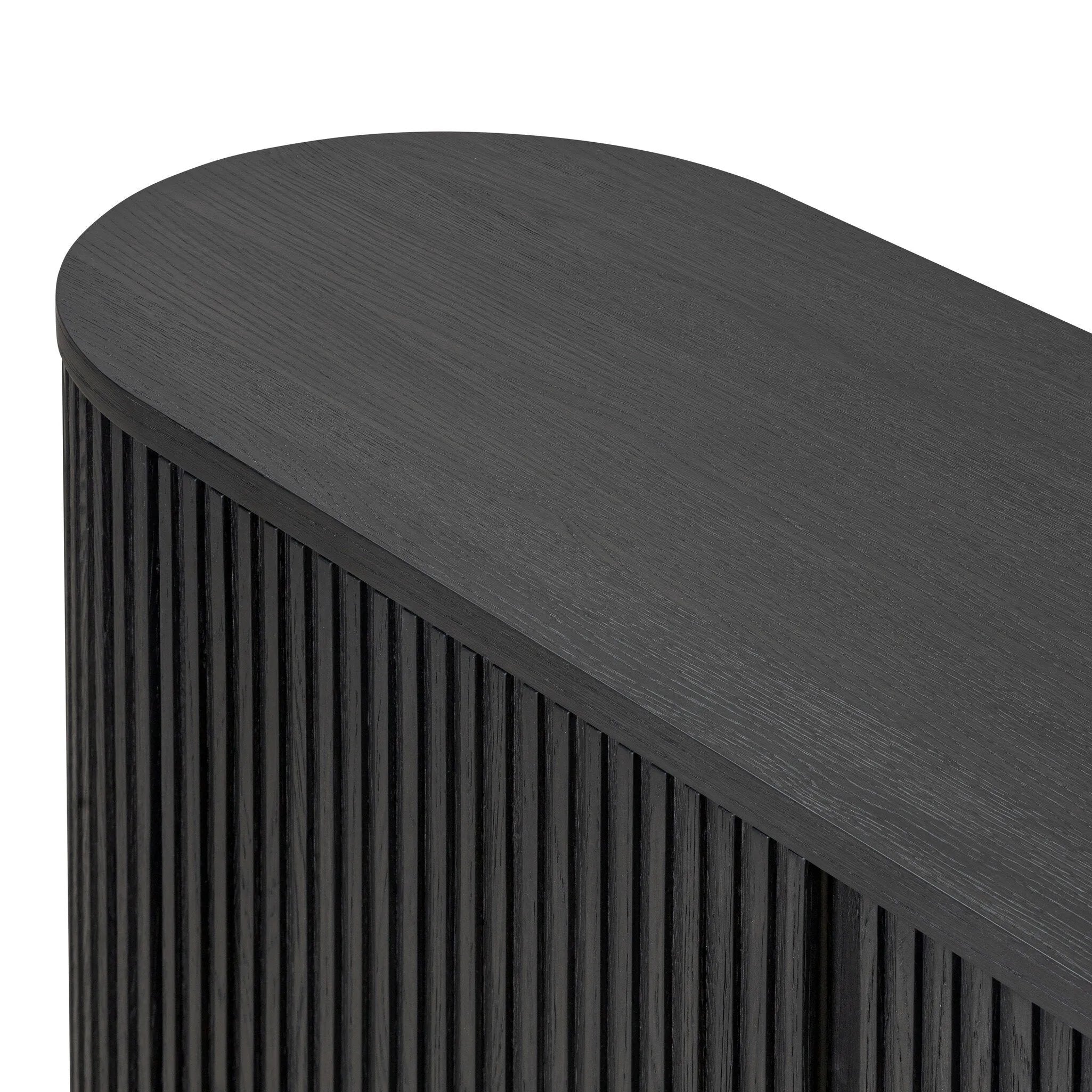 Crafted from desert oak solids and veneers with a plinth-style base, rounded sides and linear reeding, this sideboard exudes midcentury vibes. Fully finished interior and shelves for quality detailing inside and out.As enthusiasts of luxe style at Amethyst, we love the warm modern inspired Delphi Media Console - Cerused Black Oak. Amethyst Home provides interior design, new home construction design consulting, vintage area rugs, and lighting in the Omaha metro area.