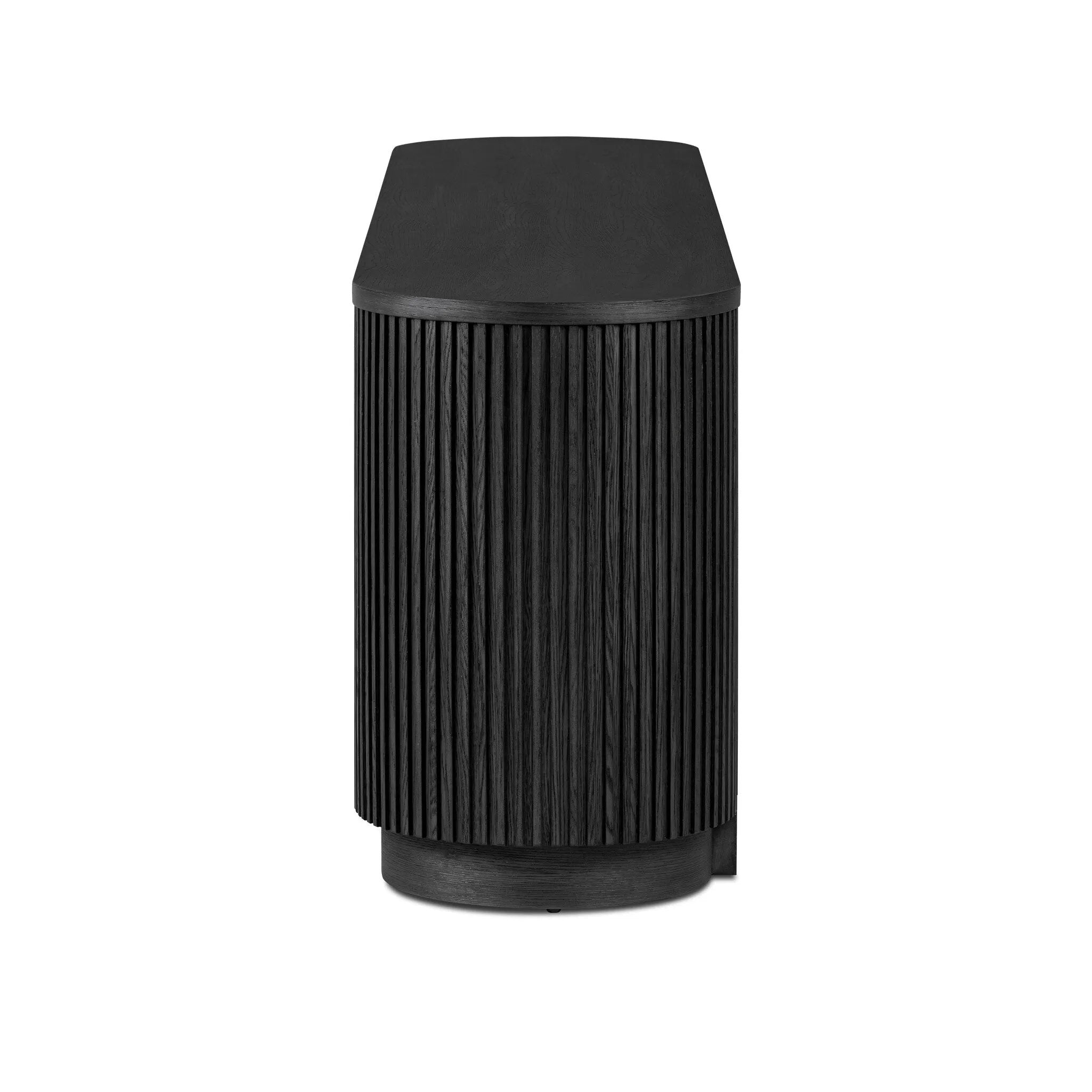 Crafted from desert oak solids and veneers with a plinth-style base, rounded sides and linear reeding, this sideboard exudes midcentury vibes. Fully finished interior and shelves for quality detailing inside and out.As enthusiasts of luxe style at Amethyst, we love the warm modern inspired Delphi Media Console - Cerused Black Oak. Amethyst Home provides interior design, new home construction design consulting, vintage area rugs, and lighting in the San Diego metro area.