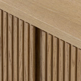 Crafted from desert oak solids and veneers with a plinth-style base, rounded sides and linear reeding, this sideboard exudes midcentury vibes.  Fully finished interior and shelves for quality detailing inside and out Amethyst Home provides interior design, new home construction design consulting, vintage area rugs, and lighting in the Portland metro area.