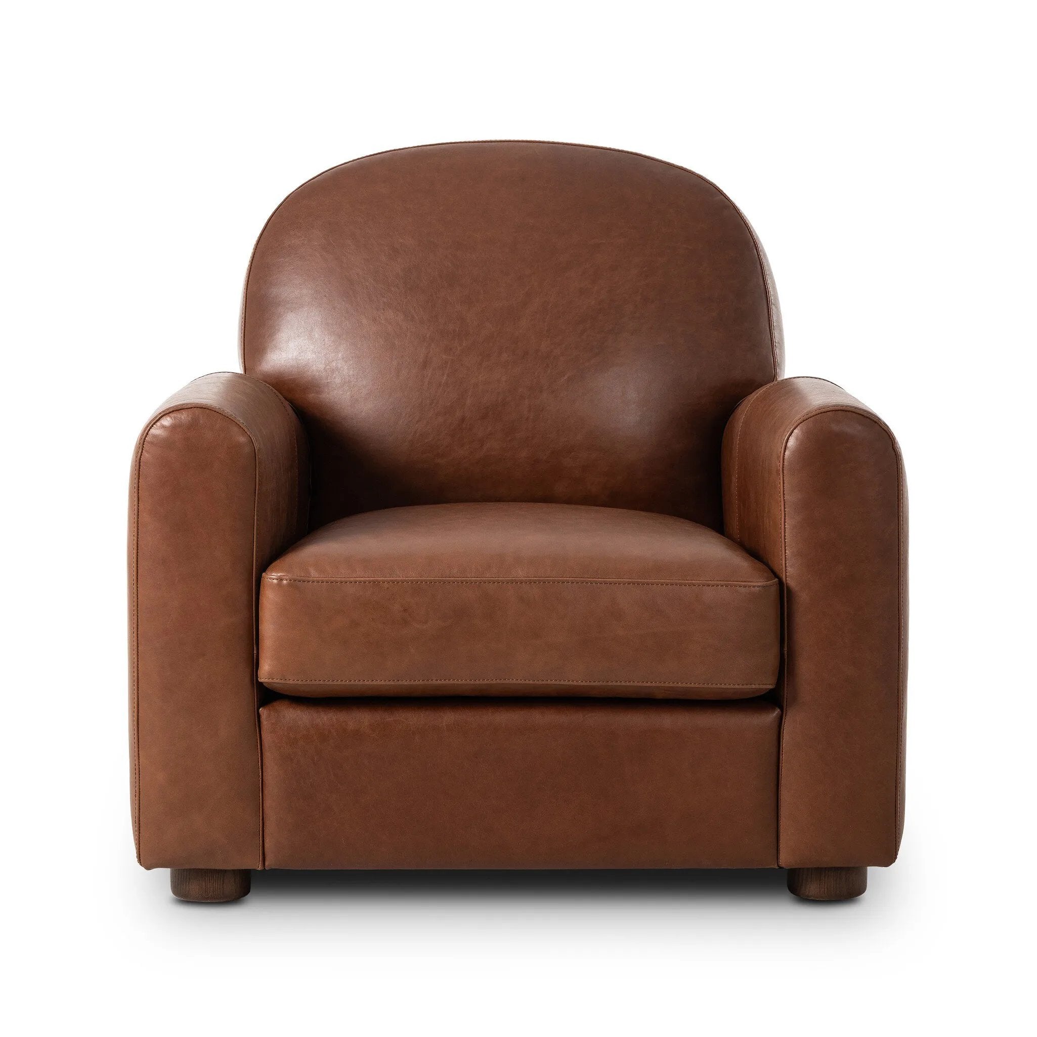 The popular Art Deco club chair makes a comeback. With a prominent curved top, deep seat with a loose cushion, and armrests designed for true relaxation, the armchair invites you to sit back and take it all in. Upholstered in rich mahogany top-grain leather. Amethyst Home provides interior design, new home construction design consulting, vintage area rugs, and lighting in the Houston metro area.