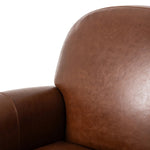 The popular Art Deco club chair makes a comeback. With a prominent curved top, deep seat with a loose cushion, and armrests designed for true relaxation, the armchair invites you to sit back and take it all in. Upholstered in rich mahogany top-grain leather. Amethyst Home provides interior design, new home construction design consulting, vintage area rugs, and lighting in the Omaha metro area.