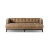 A modernized midcentury silhouette meets the traditional Chesterfield sofa, all in a compact profile perfect for smaller spaces. Top-grain leather in a tan hue, button tufting and a smooth touch bring deep comfort to lounging Amethyst Home provides interior design, new home construction design consulting, vintage area rugs, and lighting in the Des Moines metro area.
