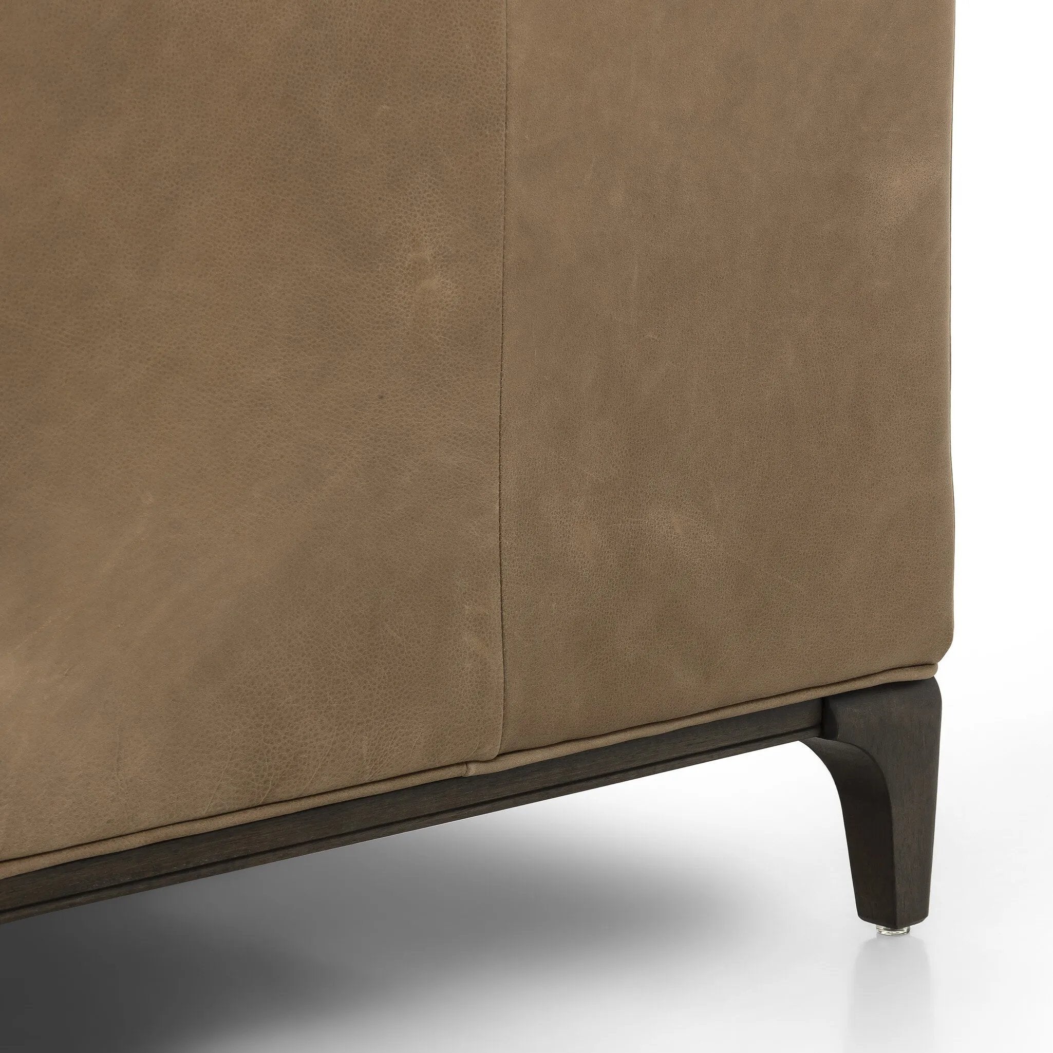 A modernized midcentury silhouette meets the traditional Chesterfield sofa, all in a compact profile perfect for smaller spaces. Top-grain leather in a tan hue, button tufting and a smooth touch bring deep comfort to lounging Amethyst Home provides interior design, new home construction design consulting, vintage area rugs, and lighting in the Los Angeles metro area.