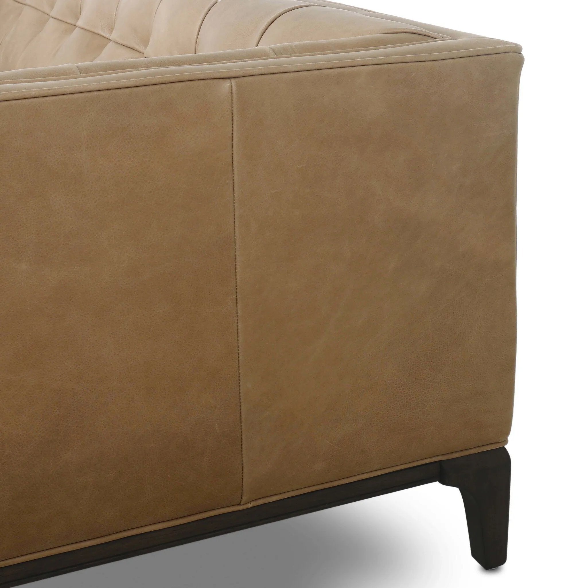 A modernized midcentury silhouette meets the traditional Chesterfield sofa, all in a compact profile perfect for smaller spaces. Top-grain leather in a tan hue, button tufting and a smooth touch bring deep comfort to lounging Amethyst Home provides interior design, new home construction design consulting, vintage area rugs, and lighting in the Miami metro area.