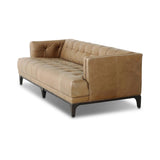 A modernized midcentury silhouette meets the traditional Chesterfield sofa, all in a compact profile perfect for smaller spaces. Top-grain leather in a tan hue, button tufting and a smooth touch bring deep comfort to lounging Amethyst Home provides interior design, new home construction design consulting, vintage area rugs, and lighting in the Portland metro area.