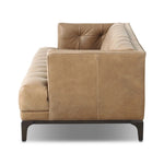 A modernized midcentury silhouette meets the traditional Chesterfield sofa, all in a compact profile perfect for smaller spaces. Top-grain leather in a tan hue, button tufting and a smooth touch bring deep comfort to lounging Amethyst Home provides interior design, new home construction design consulting, vintage area rugs, and lighting in the San Diego metro area.