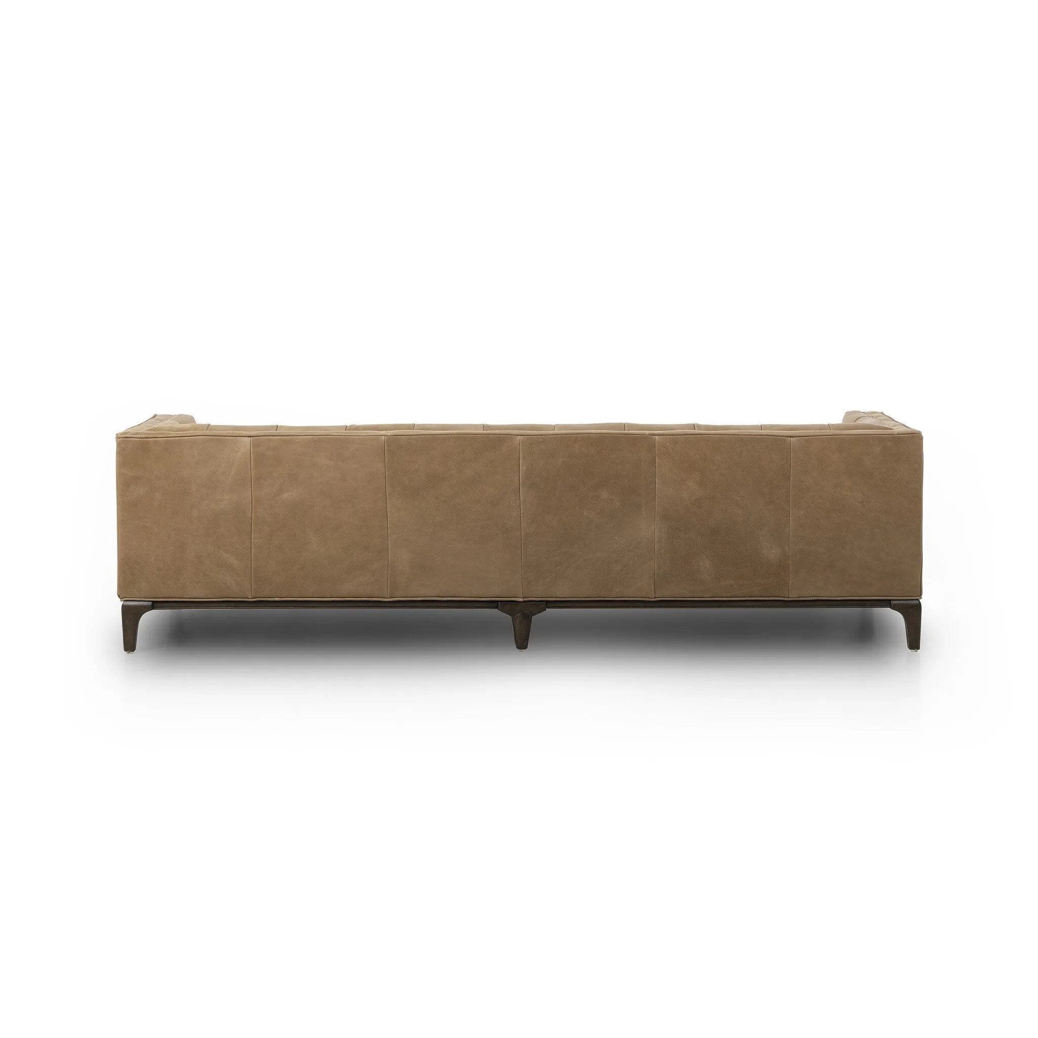 A modernized midcentury silhouette meets the traditional Chesterfield sofa, all in a compact profile perfect for smaller spaces. Top-grain leather in a tan hue, button tufting and a smooth touch bring deep comfort to lounging Amethyst Home provides interior design, new home construction design consulting, vintage area rugs, and lighting in the Scottsdale metro area.