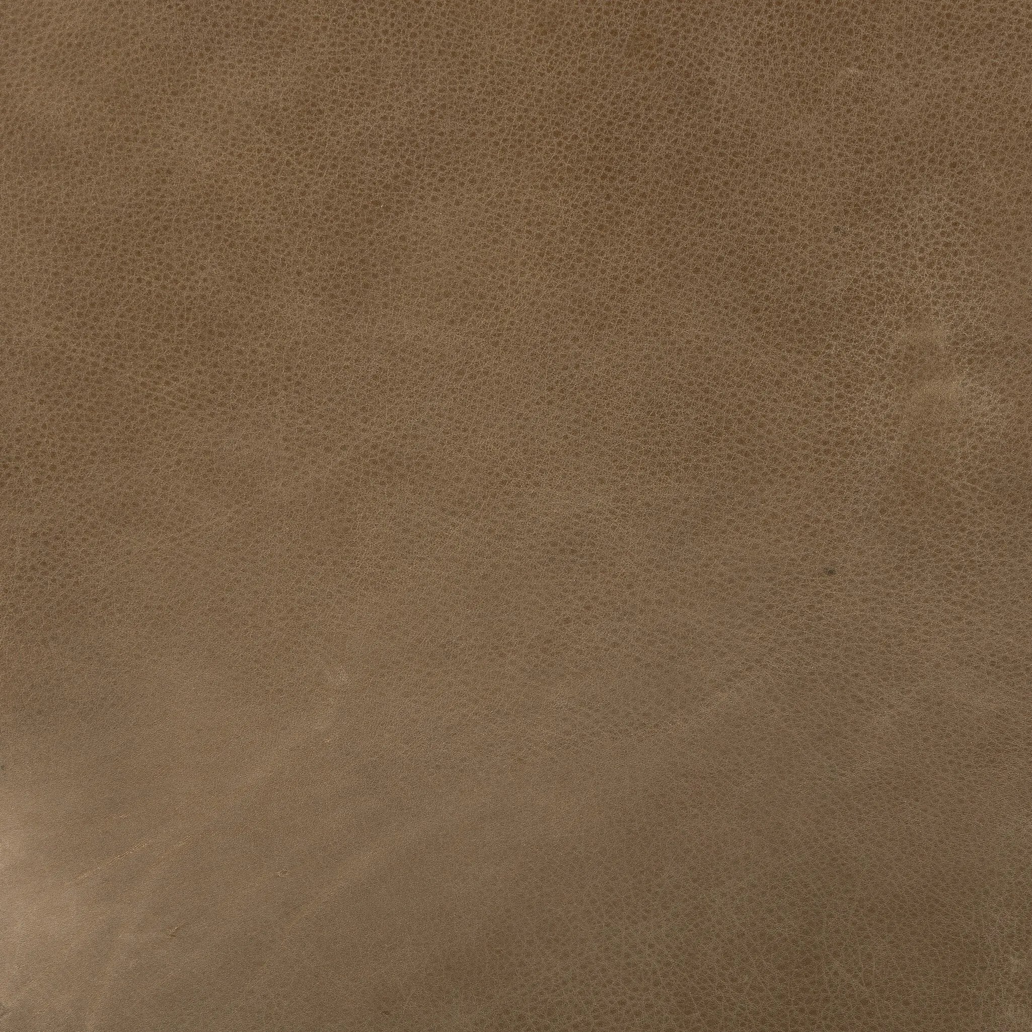 A modernized midcentury silhouette meets the traditional Chesterfield sofa, all in a compact profile perfect for smaller spaces. Top-grain leather in a tan hue, button tufting and a smooth touch bring deep comfort to lounging Amethyst Home provides interior design, new home construction design consulting, vintage area rugs, and lighting in the Seattle metro area.