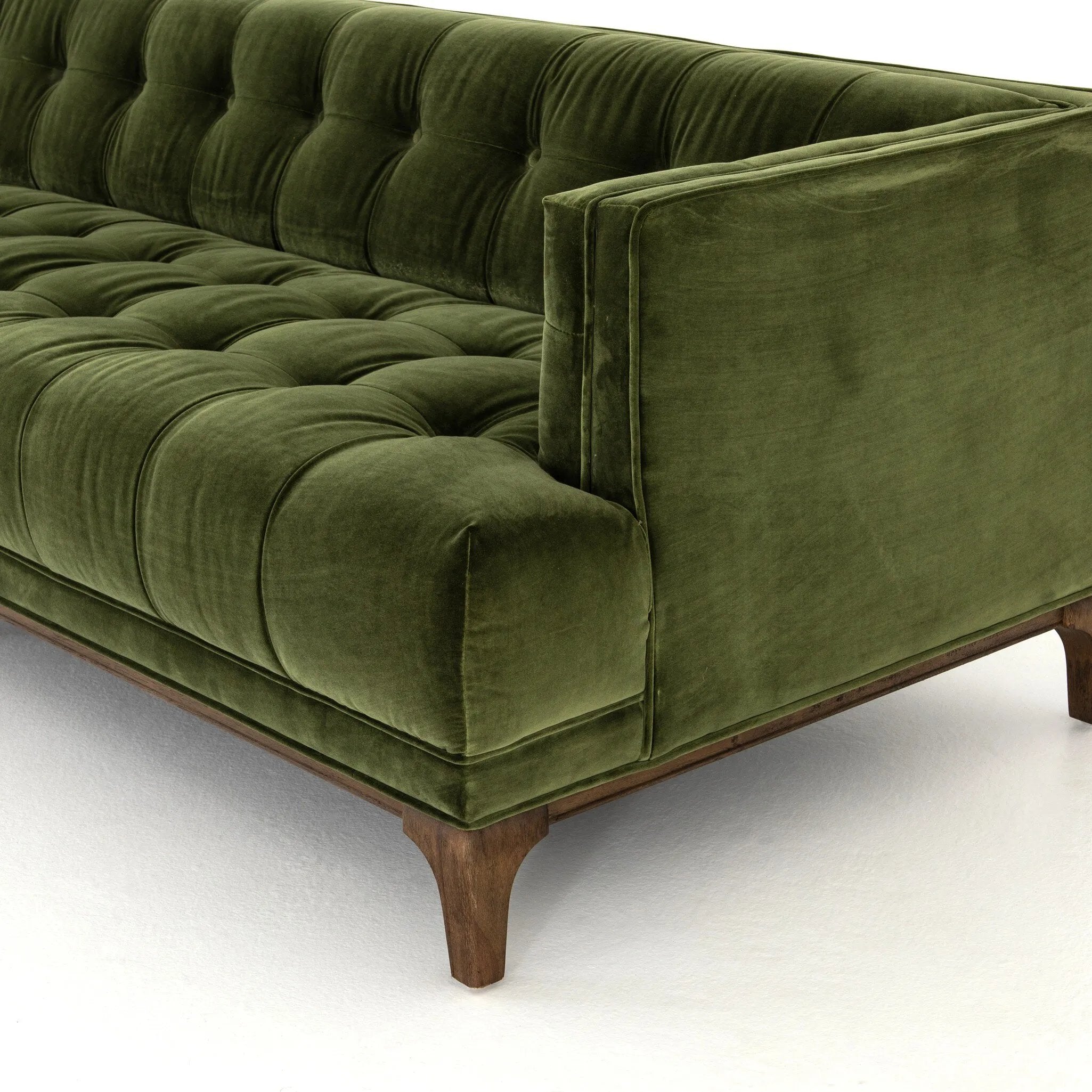 A modernized midcentury silhouette meets the traditional Chesterfield sofa, all in a compact profile perfect for smaller spaces. Smooth velvet in an olive hue, button tufting and a soft touch bring deep comfort to lounging Amethyst Home provides interior design, new home construction design consulting, vintage area rugs, and lighting in the Calabasas metro area.