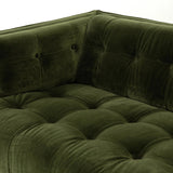 A modernized midcentury silhouette meets the traditional Chesterfield sofa, all in a compact profile perfect for smaller spaces. Smooth velvet in an olive hue, button tufting and a soft touch bring deep comfort to lounging Amethyst Home provides interior design, new home construction design consulting, vintage area rugs, and lighting in the Houston metro area.