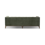 A modernized midcentury silhouette meets the traditional Chesterfield sofa, all in a compact profile perfect for smaller spaces. Smooth velvet in an olive hue, button tufting and a soft touch bring deep comfort to lounging Amethyst Home provides interior design, new home construction design consulting, vintage area rugs, and lighting in the Laguna Beach metro area.