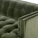 A modernized midcentury silhouette meets the traditional Chesterfield sofa, all in a compact profile perfect for smaller spaces. Smooth velvet in an olive hue, button tufting and a soft touch bring deep comfort to lounging Amethyst Home provides interior design, new home construction design consulting, vintage area rugs, and lighting in the Miami metro area.