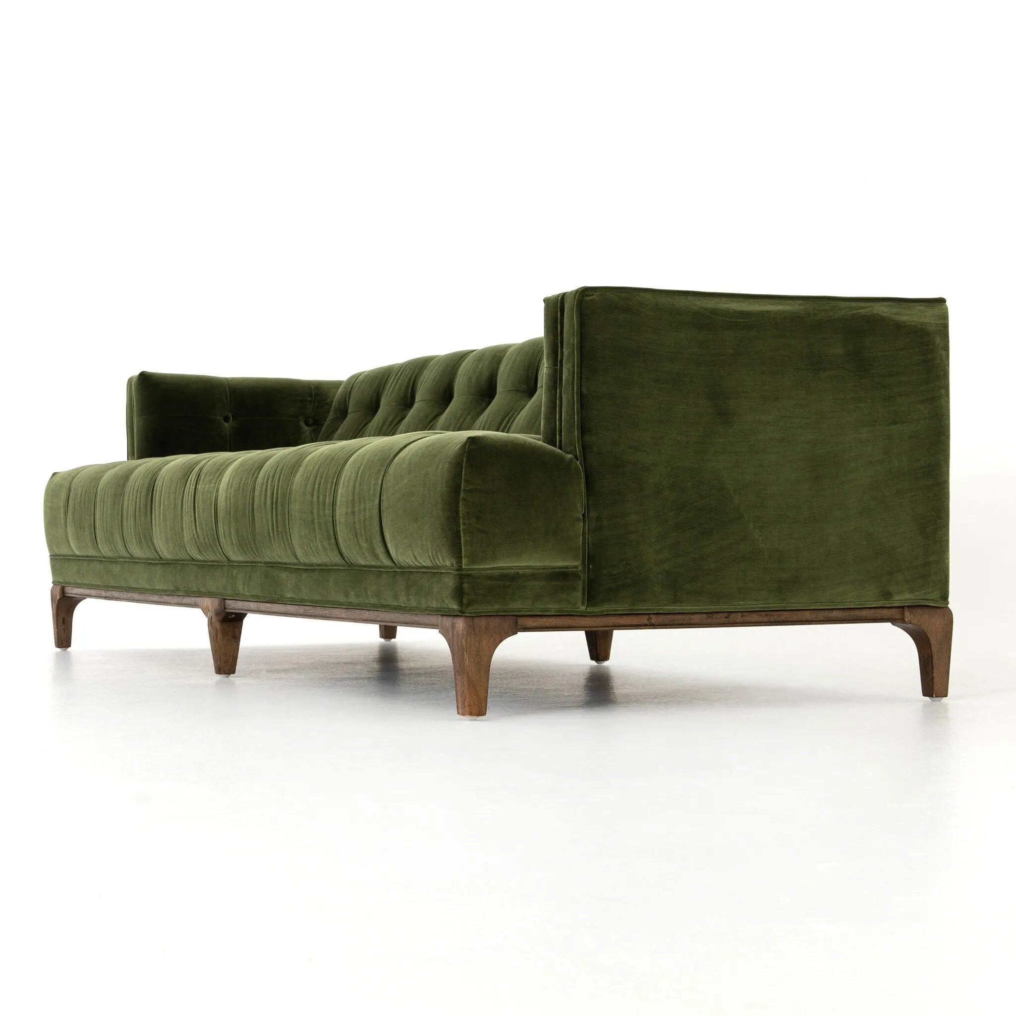A modernized midcentury silhouette meets the traditional Chesterfield sofa, all in a compact profile perfect for smaller spaces. Smooth velvet in an olive hue, button tufting and a soft touch bring deep comfort to lounging Amethyst Home provides interior design, new home construction design consulting, vintage area rugs, and lighting in the San Diego metro area.
