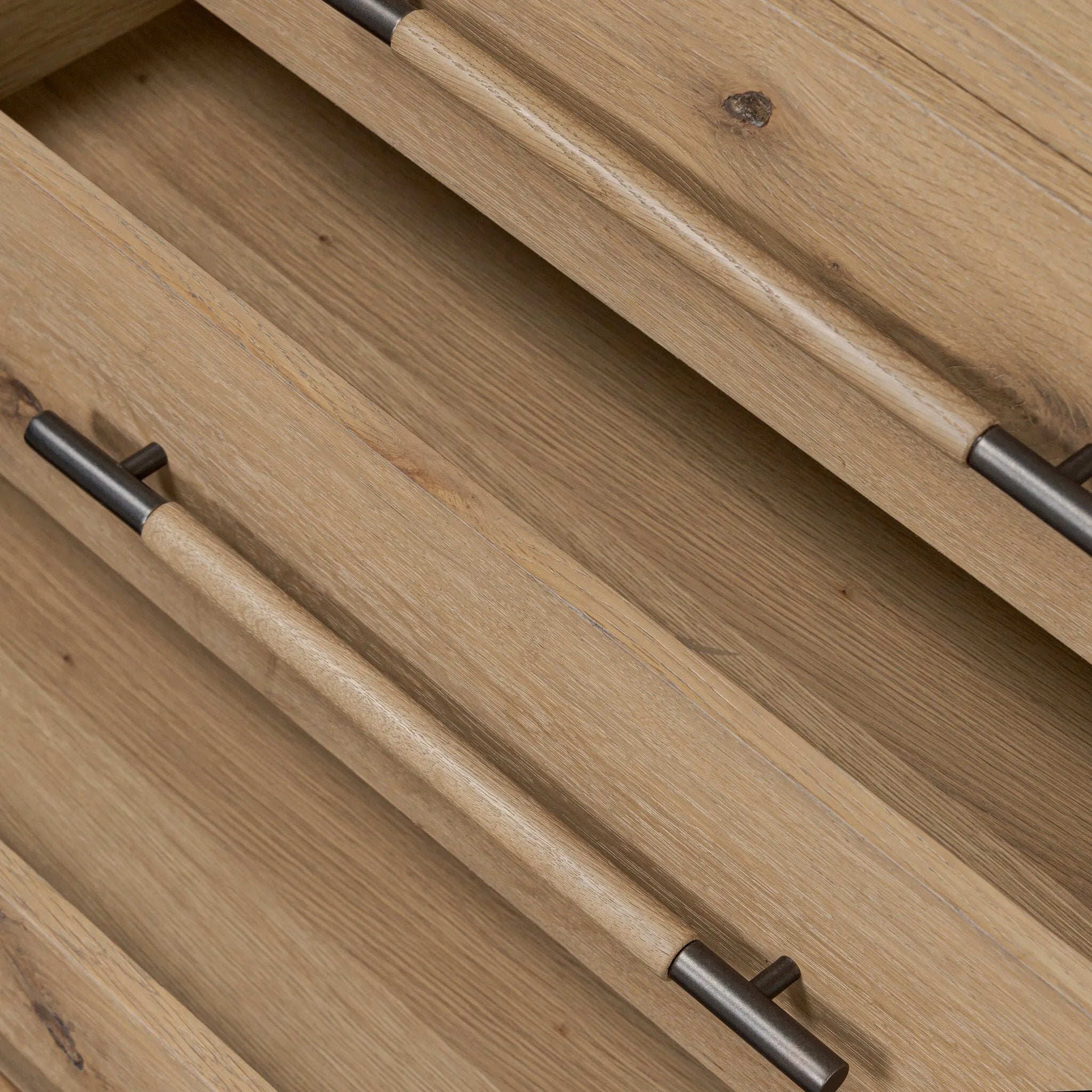 Simple and spacious, this oak nightstand has six drawers paired with aged bronze and wood hardware. Waterfall shaping and soft-close undermount glides give a smooth finish Amethyst Home provides interior design, new home construction design consulting, vintage area rugs, and lighting in the San Diego metro area.