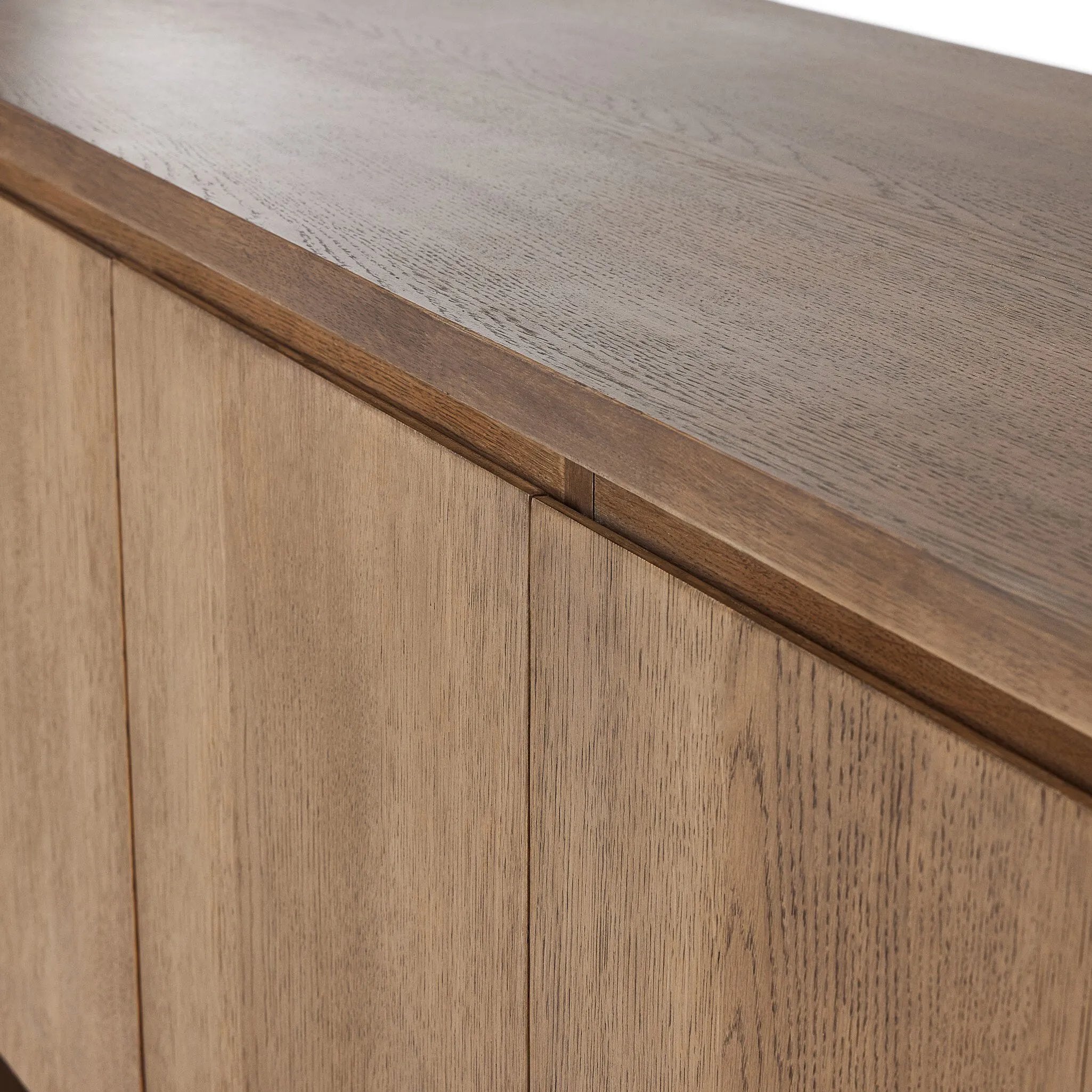 A clean-styled media console made from warm, grain-rich oak. Six doors feature subtle finger grooves for easy open. Gentle curves soften up the look, while a floating design keeps things feeling light and fresh. Inside, generous shelving awaits storage of media and more. Amethyst Home provides interior design, new home construction design consulting, vintage area rugs, and lighting in the Nashville metro area.