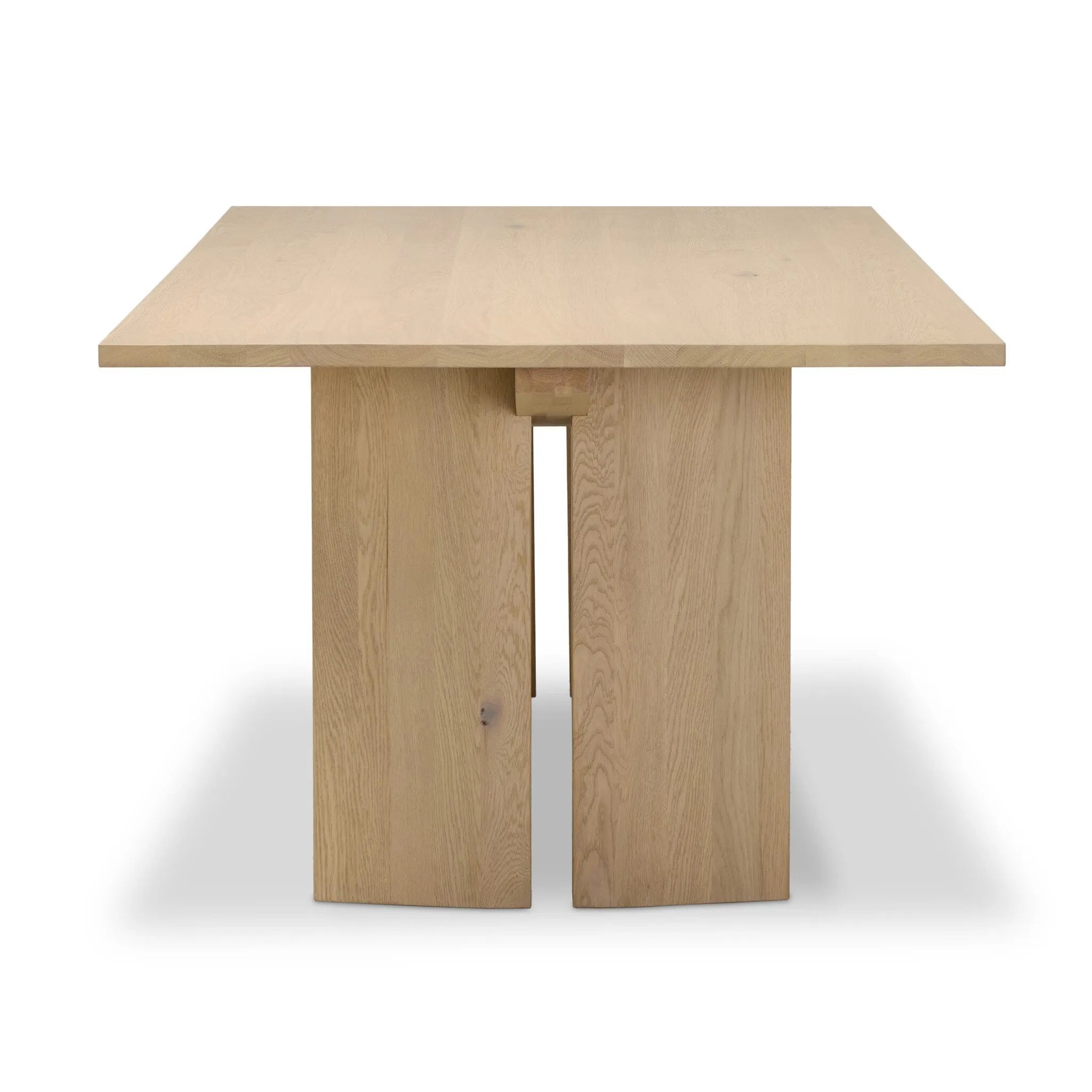 Thoughtful design details takes this long, linear dining table to the next level. Tapered shaping creates a clean, angular profile on the base, with splice leg detailing bringing a design-forward look to the whole piece. Fully crafted from bleached oak sourced from Romania. Amethyst Home provides interior design, new home construction design consulting, vintage area rugs, and lighting in the Los Angeles metro area.