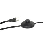 A dramatically curved silhouette and tripod base of matte black metal pair with a flax linen shade for this floor lamp's shapely, minimalist feel Amethyst Home provides interior design, new home construction design consulting, vintage area rugs, and lighting in the Austin metro area.