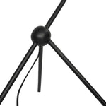 A dramatically curved silhouette and tripod base of matte black metal pair with a flax linen shade for this floor lamp's shapely, minimalist feel Amethyst Home provides interior design, new home construction design consulting, vintage area rugs, and lighting in the Salt Lake City metro area.